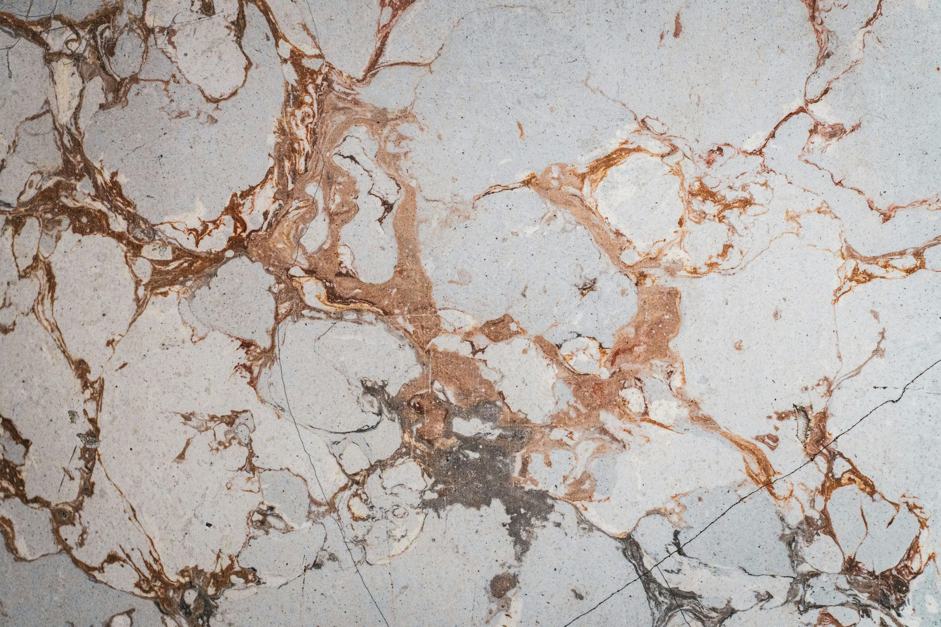 White marble surface with brown and grey veins
